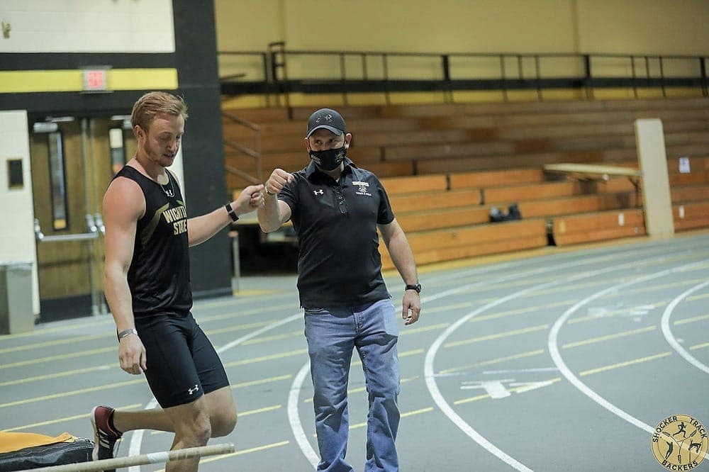 Athletes celebrating with a fist bump